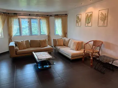 a living room with a couch and a table at MAGICAL HOMESTAY CAMERON HIGHLANDS in Cameron Highlands