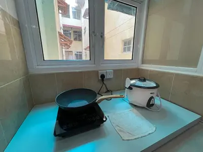 a kitchen counter with a pot and a toaster and a window at MAGICAL HOMESTAY CAMERON HIGHLANDS in Cameron Highlands