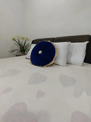 a blue pillow sitting on top of a bed at Cozy Suite for 2-6 pax near Kek Lok Si, Penang Hill, Sunshine Central in Ayer Itam