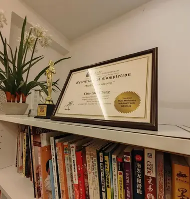 a framed picture sitting on a shelf with books at Cozy Suite for 2-6 pax near Kek Lok Si, Penang Hill, Sunshine Central in Ayer Itam