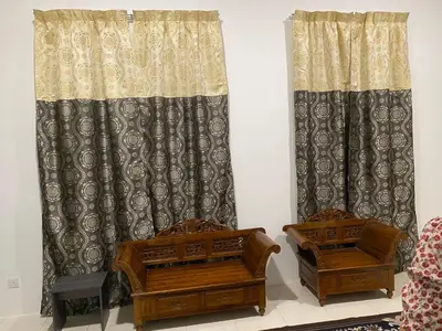 two wooden chests and curtains in a room at An-Nur Homestay in Sungai Petani
