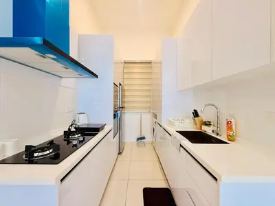 a white kitchen with a sink and a stove at New Georgetown Stylist 2BR Homestay for 10pax \u65e0\u654c\u7f8e\u666f\u4e24\u623f\u6c11\u5bbf Beacon Executive Suite in George Town