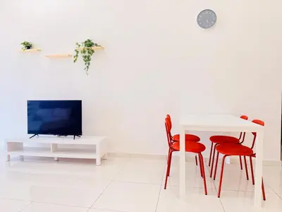 a living room with a white table and red chairs at New Georgetown Stylist 2BR Homestay for 10pax \u65e0\u654c\u7f8e\u666f\u4e24\u623f\u6c11\u5bbf Beacon Executive Suite in George Town