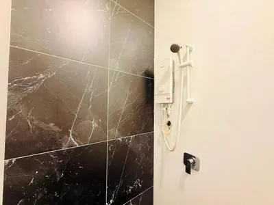 a bathroom door with a black marble wall at New Georgetown Stylist 2BR Homestay for 10pax \u65e0\u654c\u7f8e\u666f\u4e24\u623f\u6c11\u5bbf Beacon Executive Suite in George Town