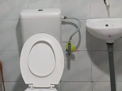 a bathroom with a toilet and a sink at Izz Homestay Sawah Padi Sungai Besar ! in Kampong Parit Ten