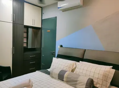 a bedroom with a bed and a black cabinet at Dual Key 3BR at Macalister 218 Georgetown 32 WL in George Town