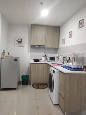 a kitchen with a washing machine and a refrigerator at Dual Key 3BR at Macalister 218 Georgetown 32 WL in George Town