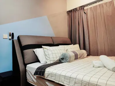 a bedroom with a bed with a blanket and pillows at Dual Key 3BR at Macalister 218 Georgetown 32 WL in George Town