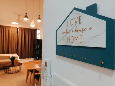 a living room with a sign that reads love under a have a home at N New Georgetown Instagramable 2BR Homestay for 10pax \u65e0\u654c\u7f8e\u666f\u4e24\u623f\u6c11\u5bbf Beacon Executive Suite in George Town