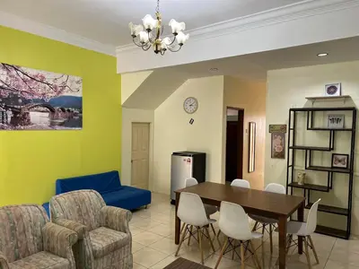 a living room with a dining room table and chairs at Jarzmin Double Story Homestay @ Royal Lily in Tanah Rata