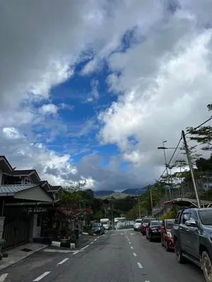 a street with cars parked on the side of the road at Jarzmin Double Story Homestay @ Royal Lily in Tanah Rata