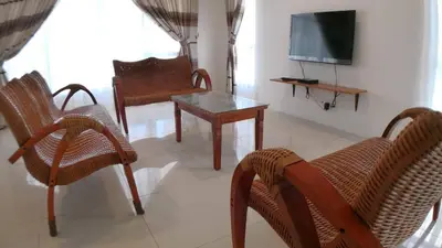 a living room with chairs and a table and a television at HOMESTAY CAMERON HIGHLANDS GOLDEN HILL 5BR SEMI D GOLDEN HILLS NIGHT Market NO BBQ in Brinchang