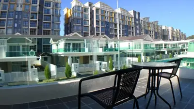 a balcony with a table and chairs and some buildings at HOMESTAY CAMERON HIGHLANDS GOLDEN HILL 5BR SEMI D GOLDEN HILLS NIGHT Market NO BBQ in Brinchang