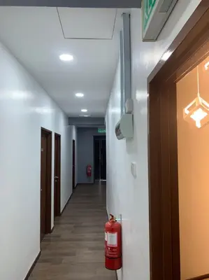 a hallway with a fire hydrant in a building at Hi TechSTAY in Lunas