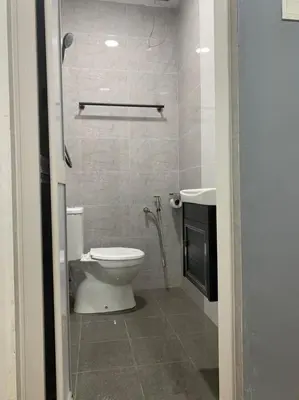 a bathroom with a toilet and a sink at Hi TechSTAY in Lunas