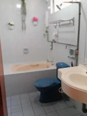 a bathroom with a toilet and a tub and a sink at Apartment Teluk Batik in Lumut