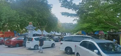 a group of cars parked in a parking lot at Apartment Teluk Batik in Lumut
