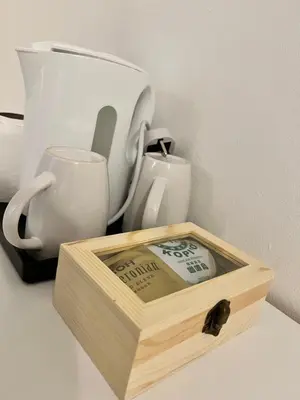 a wooden box sitting on a counter next to a cup at Bertam Cottage Penang in Kepala Batas