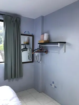 a bedroom with blue walls and a window and shelves at Pangkor Coralbay Resort Room 208 apartment in Pangkor
