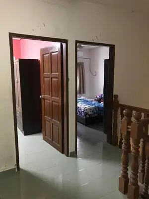 a room with two doors and a bedroom with a bed at Suria Permai Homestay in Taiping