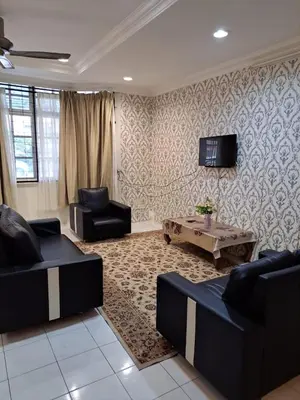 a living room with two couches and a coffee table at Suria Permai Homestay in Taiping