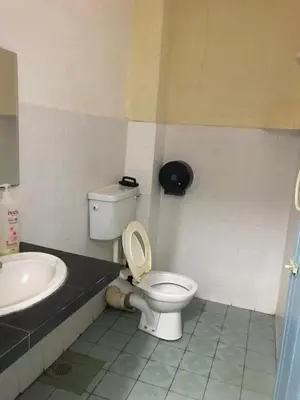 a bathroom with a toilet and a sink at Suria Permai Homestay in Taiping