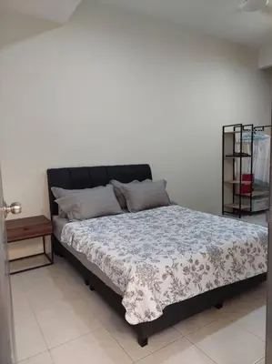 a bedroom with a bed with a black headboard at Yong Guesthouse in Kuala Kangsar