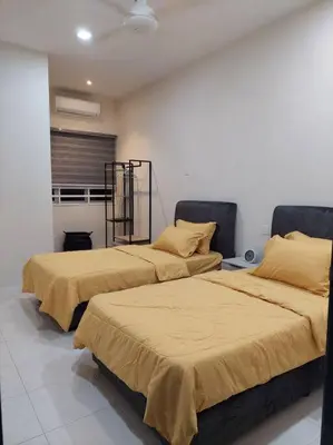 two beds sitting next to each other in a room at Yong Guesthouse in Kuala Kangsar