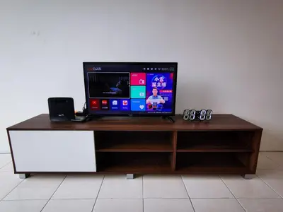 a tv sitting on top of a wooden entertainment center at Happy homestay pulau pangkor in Kampong Sungai Udang