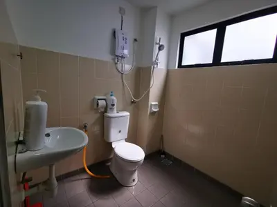 a bathroom with a white toilet and a sink at Happy homestay pulau pangkor in Kampong Sungai Udang