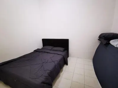 a bedroom with two beds and a tiled floor at Happy homestay pulau pangkor in Kampong Sungai Udang