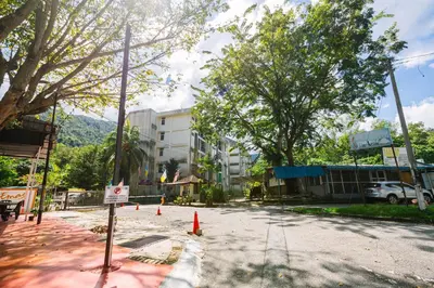 an empty street with orange cones on the road at EE's Beach House - Homestay 3 min walk to beach in Batu Ferringhi
