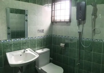 a bathroom with a shower and a toilet and a sink at Cyber Loft Homestay in Ipoh