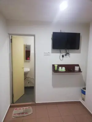 a room with a flat screen tv on a wall at Evonne Budget Hotel in Tanah Rata