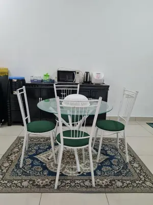 a table with two chairs and a table and a table and chairsktop at Embon Homestay in Padang Serai