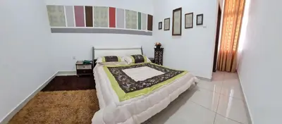 a bedroom with a large bed in a room at Embon Homestay in Padang Serai