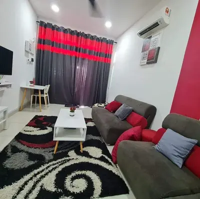 a living room with a couch and a table at Embon Homestay in Padang Serai