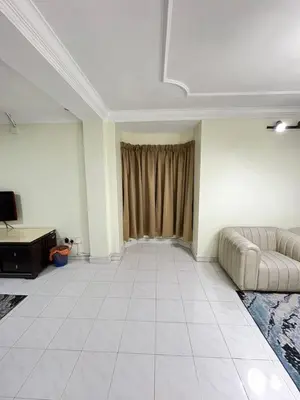 a living room with a couch and a window at Azzalea 3-Bedroom Apartment Cameron Highlands in Tanah Rata
