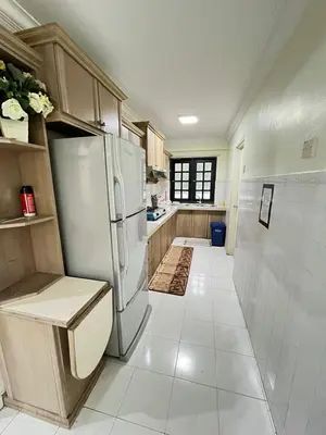 a kitchen with a refrigerator and a tile floor at Azzalea 3-Bedroom Apartment Cameron Highlands in Tanah Rata