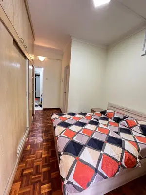 a bedroom with a bed with a colorful quilt at Azzalea 3-Bedroom Apartment Cameron Highlands in Tanah Rata