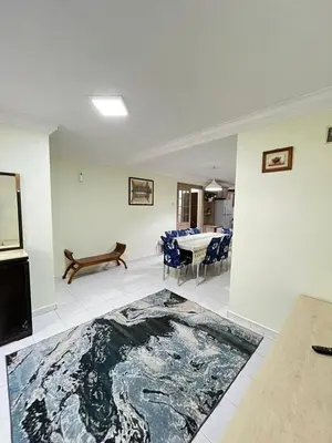 a living room with a table and a rug on the floor at Azzalea 3-Bedroom Apartment Cameron Highlands in Tanah Rata