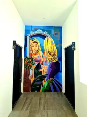 a mural on the wall of a room with a painting at Beacon Executive Suites - George Town in George Town