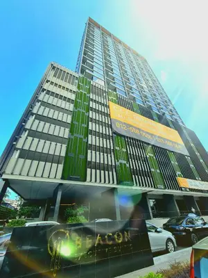 a tall building with a car parked in front of it at Beacon Executive Suites - George Town in George Town