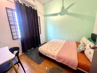 a bedroom with a bed with a shadow on the wall at Entire Cozy Home 16 • 3 bedroom @ Alma Bukit Mertajam in Bukit Mertajam