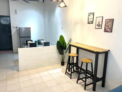 a counter with two stools in a room at Entire Cozy Home 16 • 3 bedroom @ Alma Bukit Mertajam in Bukit Mertajam