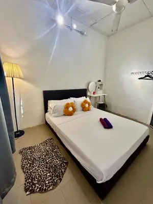 a bedroom with a bed with two teddy bears on it at Entire 33 Cozy House • 3 Bedroom @ Alma Bukit Mertajam in Bukit Mertajam