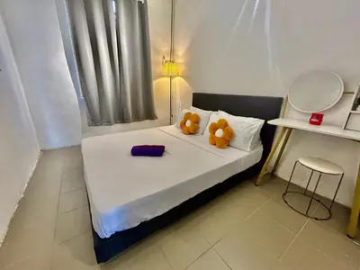 two teddy bears sitting on a bed in a room at Entire 33 Cozy House • 3 Bedroom @ Alma Bukit Mertajam in Bukit Mertajam