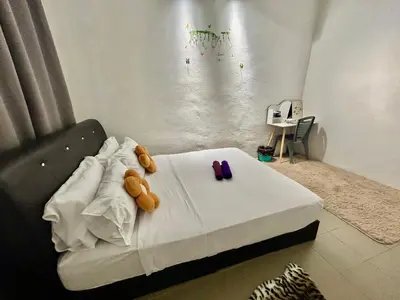 a bedroom with a bed with two teddy bears on it at Entire 33 Cozy House • 3 Bedroom @ Alma Bukit Mertajam in Bukit Mertajam