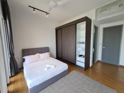 a bedroom with a white bed and a closet at Beacon Executive Suites in George Town