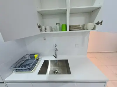 a kitchen with a sink and a counter top at Beacon Executive Suites in George Town